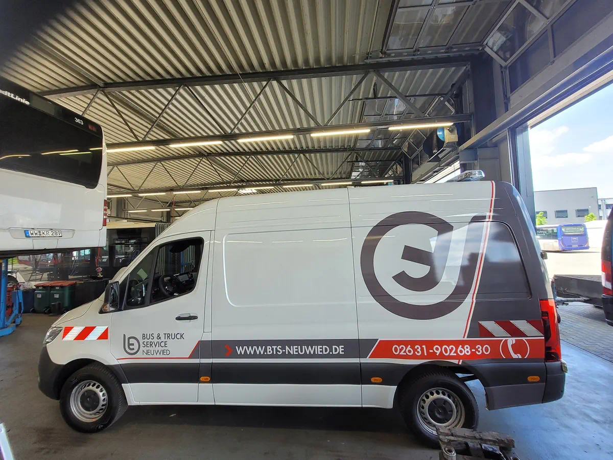 Dillschn Sprinter mit professioneller Fahrzeugbeschriftung und auffälliger Folierung für Bus & Truck Service Neuwied.